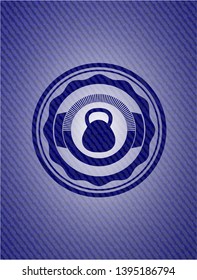 kettlebell icon inside emblem with denim high quality background