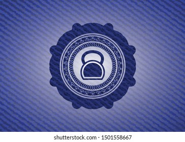kettlebell icon inside emblem with denim texture