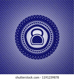 kettlebell icon inside emblem with jean background