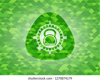 kettlebell icon inside green emblem with triangle mosaic background