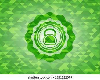 kettlebell icon inside green emblem with mosaic ecological style background