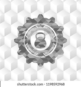 kettlebell icon inside grey badge with geometric cube white background