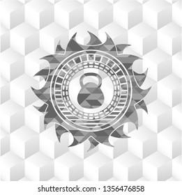 kettlebell icon inside grey badge with geometric cube white background