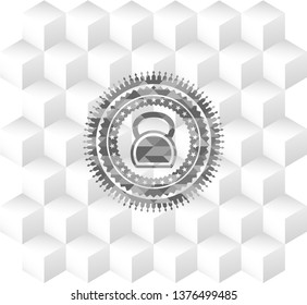 kettlebell icon inside grey badge with geometric cube white background