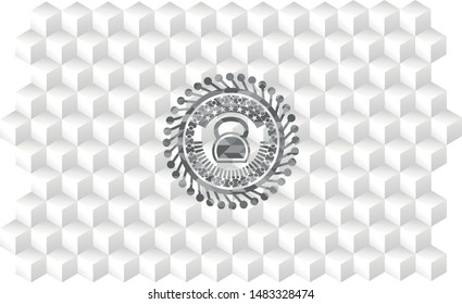 kettlebell icon inside grey badge with geometric cube white background
