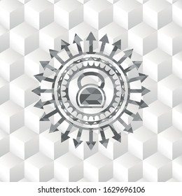 kettlebell icon inside grey badge with geometric cube white background