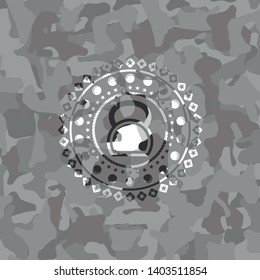 kettlebell icon inside grey camo emblem