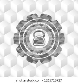 kettlebell icon inside grey emblem with geometric cube white background