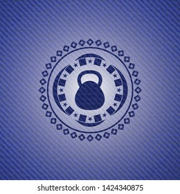 kettlebell icon inside jean or denim emblem or badge background