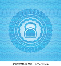 kettlebell icon inside light blue water wave emblem background.