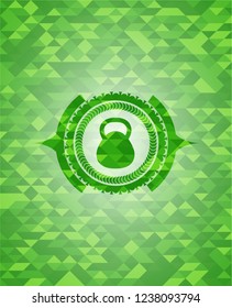 kettlebell icon inside realistic green mosaic emblem