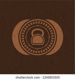 kettlebell icon inside retro style wooden emblem