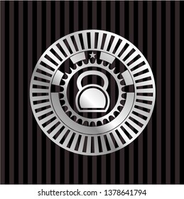 kettlebell icon inside silvery badge