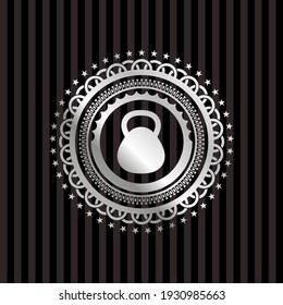 kettlebell icon inside silvery badge or emblem. 
