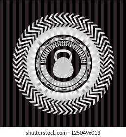 kettlebell icon inside silvery emblem or badge