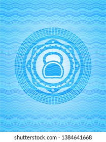 kettlebell icon inside sky blue water wave style badge.
