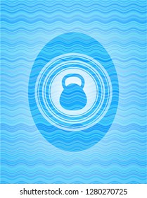 kettlebell icon inside water style emblem.