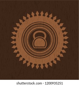 kettlebell icon inside wood badge or emblem