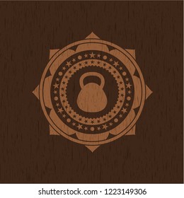 kettlebell icon inside wood badge or emblem