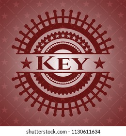 Key badge with red background