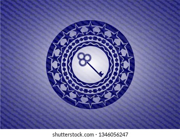 key icon inside badge with denim texture