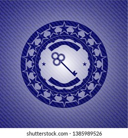 key icon inside badge with denim texture