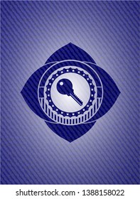 key icon inside badge with denim background