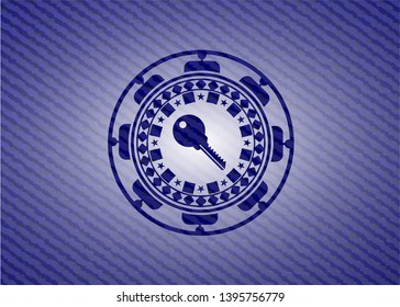 key icon inside badge with denim texture