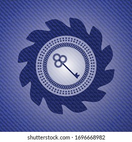 key icon inside badge with denim texture