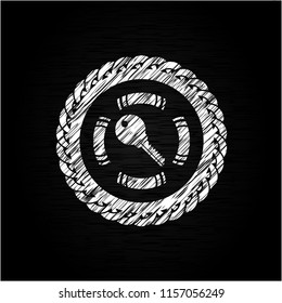 key icon inside chalk emblem written on a blackboard