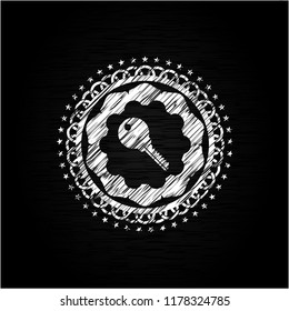 key icon inside chalkboard emblem
