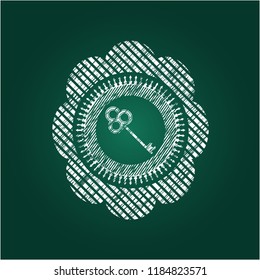 key icon inside chalkboard emblem
