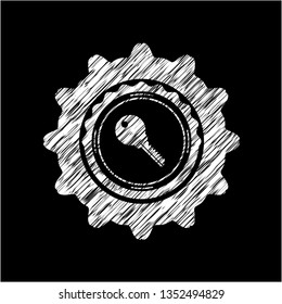 key icon inside chalkboard emblem on black board