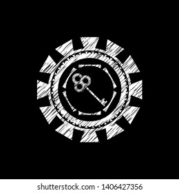 key icon inside chalkboard emblem on black board