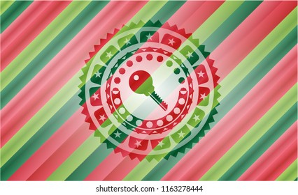 key icon inside christmas colors style badge.