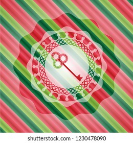 key icon inside christmas colors style emblem.