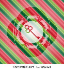 key icon inside christmas emblem.
