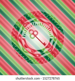 key icon inside christmas style emblem.