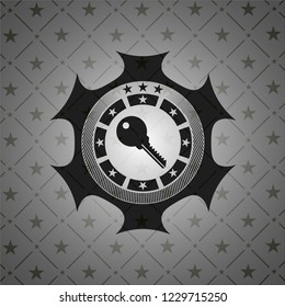 key icon inside dark emblem