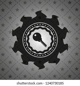 key icon inside dark emblem