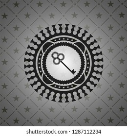 key icon inside dark emblem