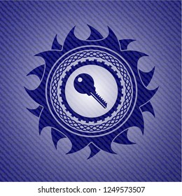 key icon inside emblem with denim high quality background