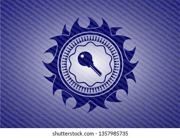 key icon inside emblem with denim high quality background