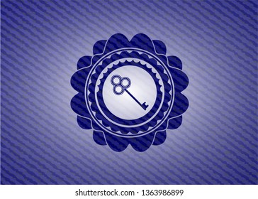 key icon inside emblem with denim high quality background