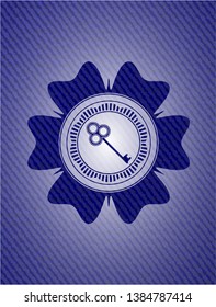 key icon inside emblem with denim texture