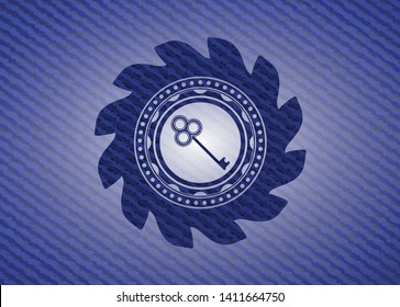 key icon inside emblem with denim texture