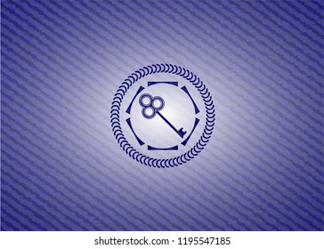 key icon inside emblem with jean background