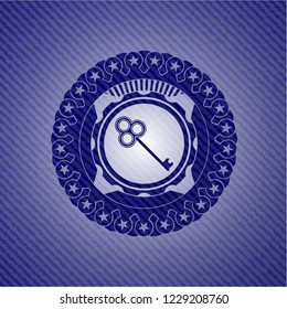 key icon inside emblem with jean background