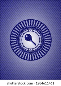 key icon inside emblem with jean background
