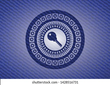 key icon inside emblem with jean background